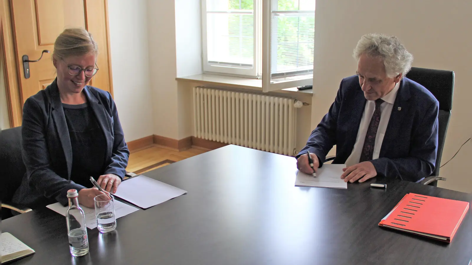 Dr. Lea Schütze und Landrat Helmut Petz bei der Vertragsunterzeichnung. (Foto: LRA)