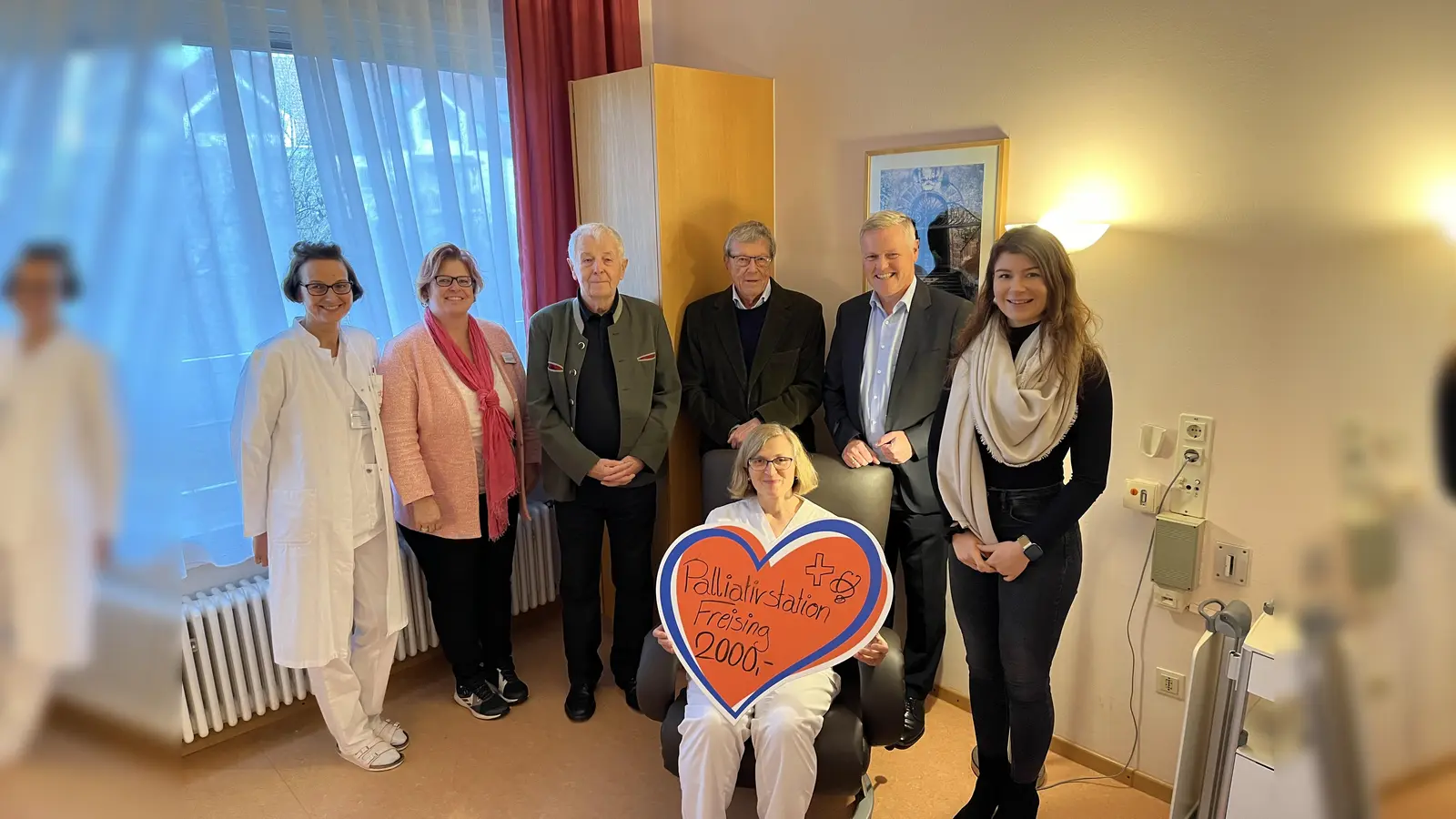 Den Besucherstuhl in Augenschein genommen haben v. l. n. r.: Renate Borchert Anästhesie, Anja Bertelmann-Gschlößl, Wolf-Dieter Glöckner und Dr. Bernhard Helmreich (Förderverein Palliativstation), Reinhard Schwaiger und Eva Prehm (Freisinger Bank). Den Stuhl getestet hat Dr. Irmgard Frey. (Foto: Freisinger Bank)